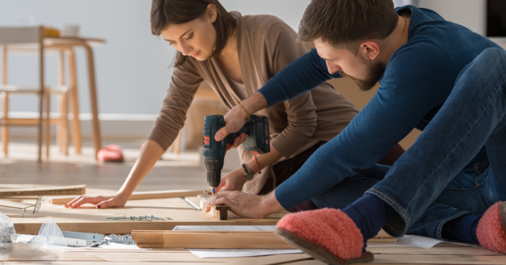 man using drill to assemble furniture 