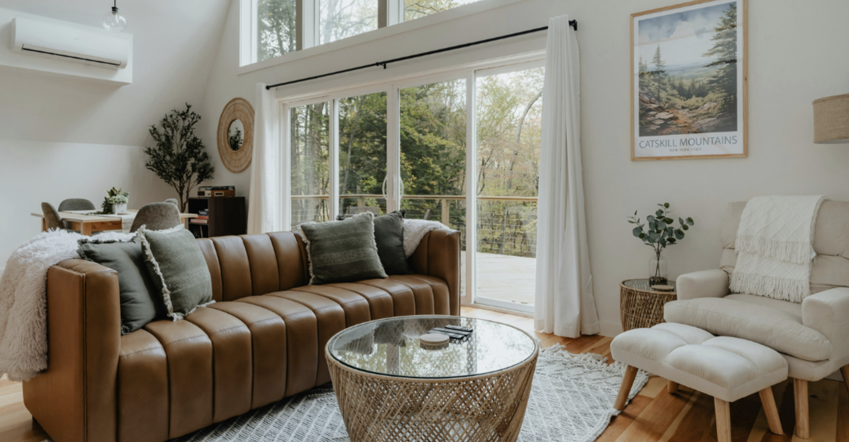 living room with couch, table, large windows 