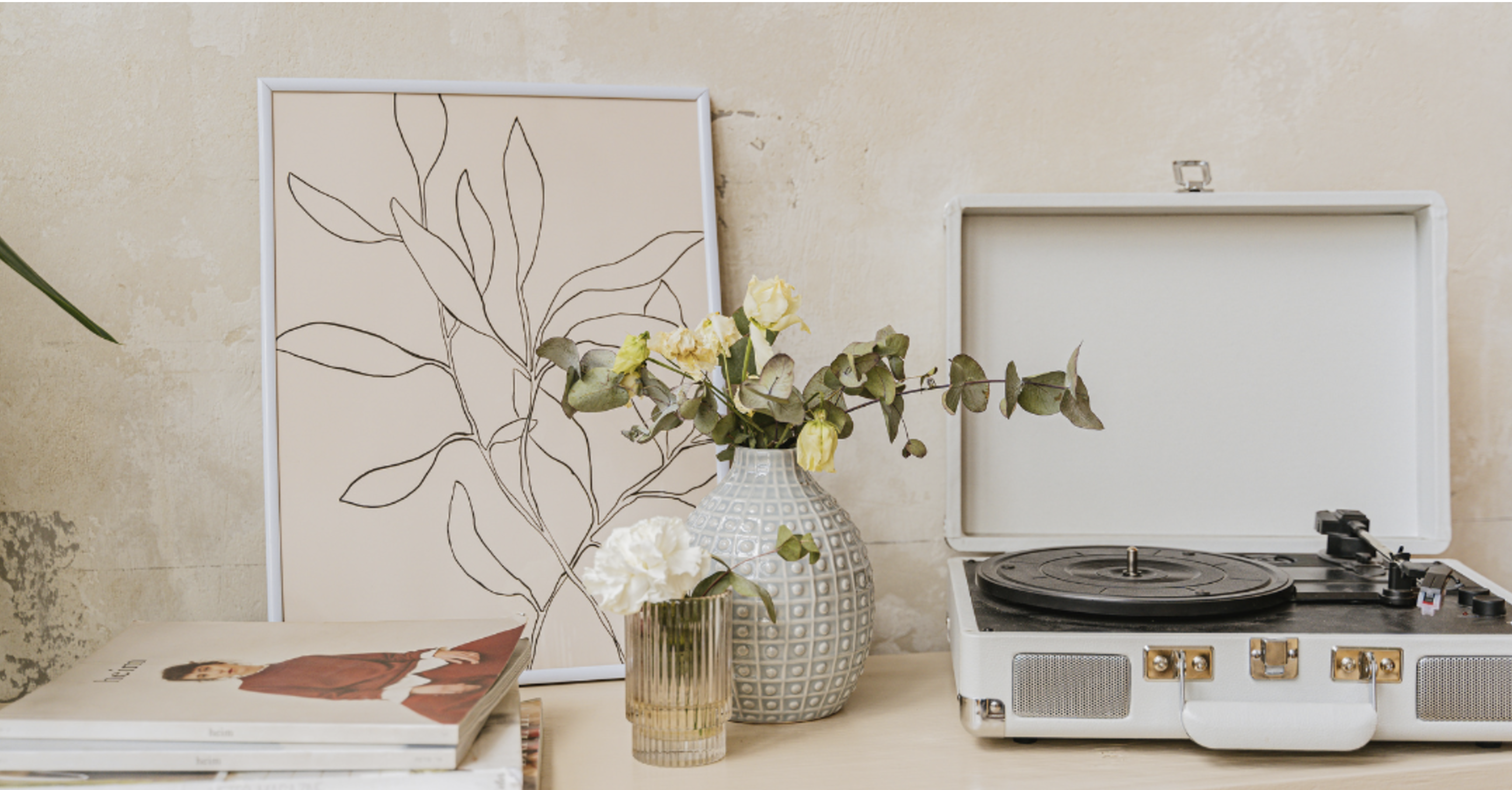 table with a vase of flowers, art, record player