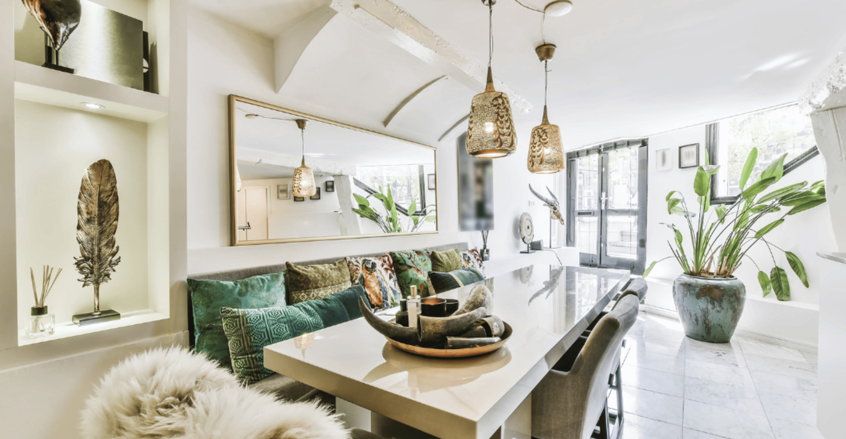 dining area with a large table, natural sunlight, plants, and accessories