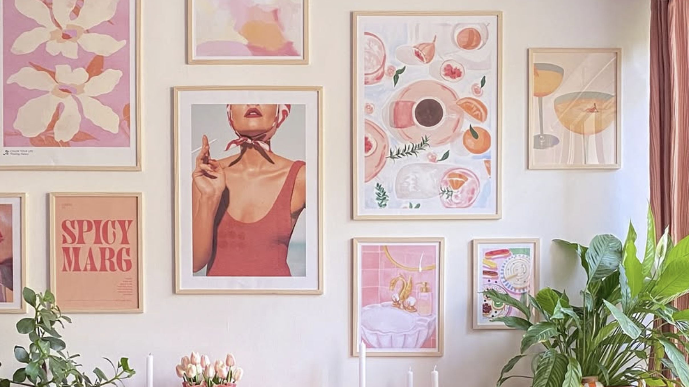 Gallery wall of framed images in coordinating colors.