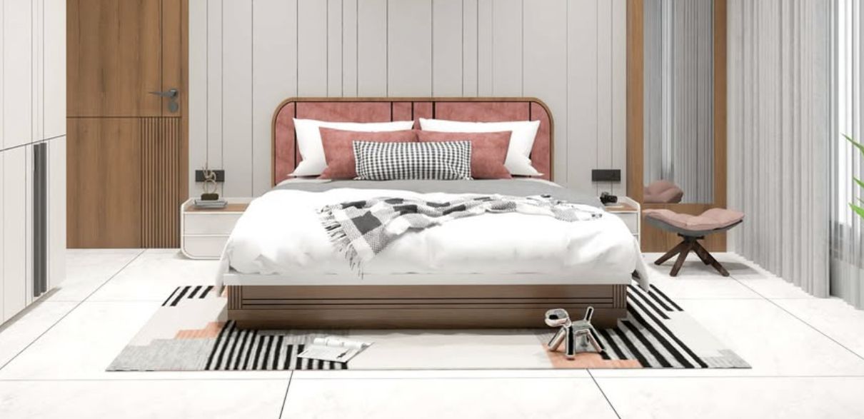 Large bedroom with a king sized bed centered against one wall and a coordinating rugs sits below.